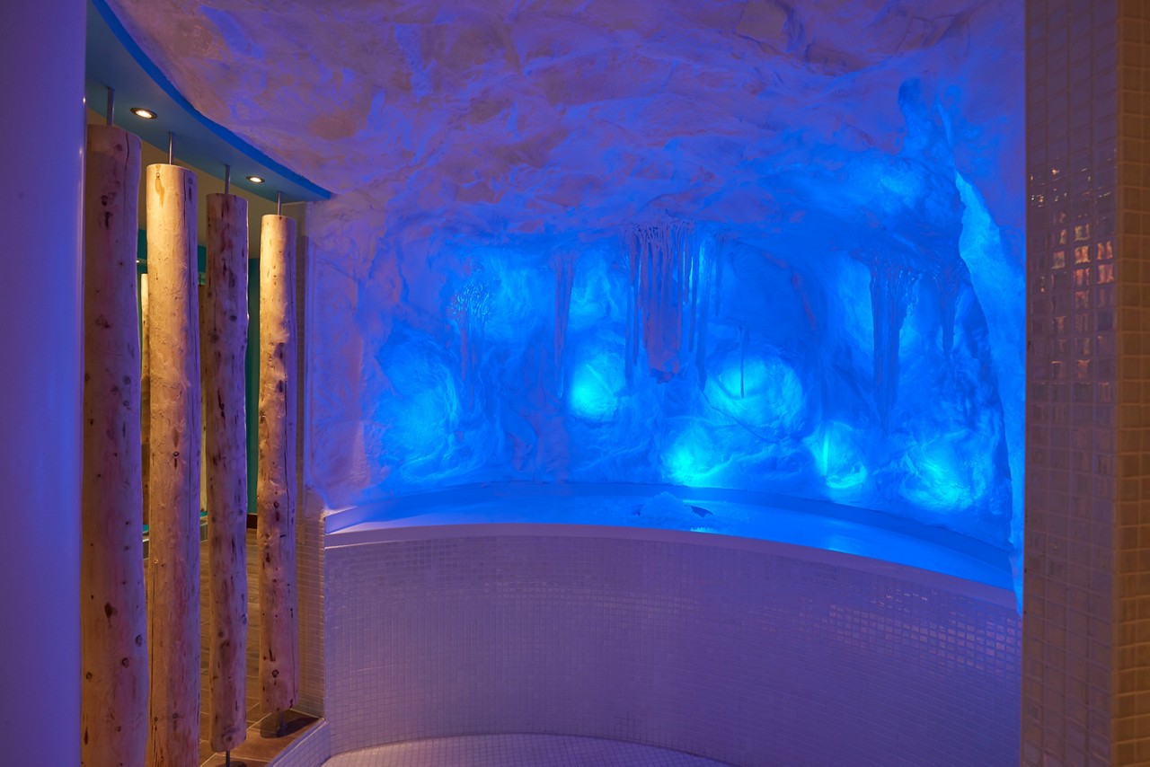 Cold room made of ice with glowing coloured lights.